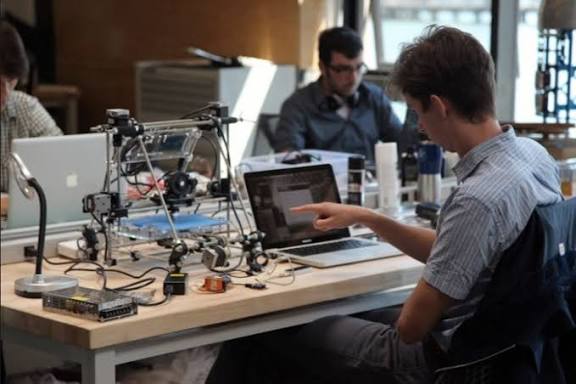 Hardware startup engineers developing and testing an electronic circuit board